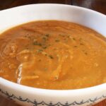 A bowl of sweet potato and apple soup.