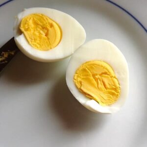A hard boiled egg cut in half.