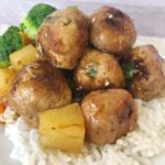 sweet and sour pork meatballs on a bed of rice
