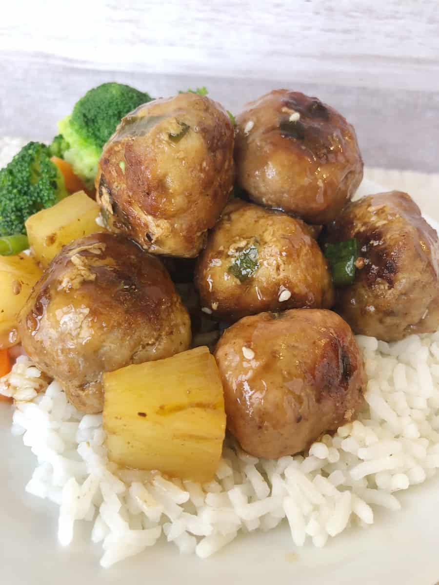 sweet and sour pork meatballs on a bed of rice