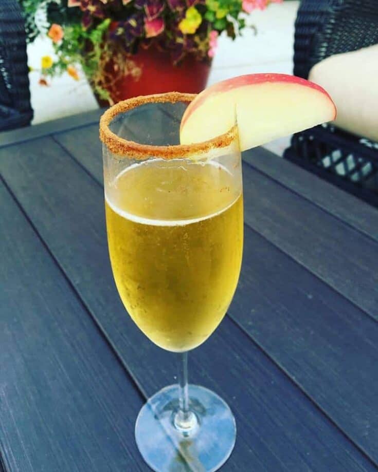 champagne flute of apple cider mimosa