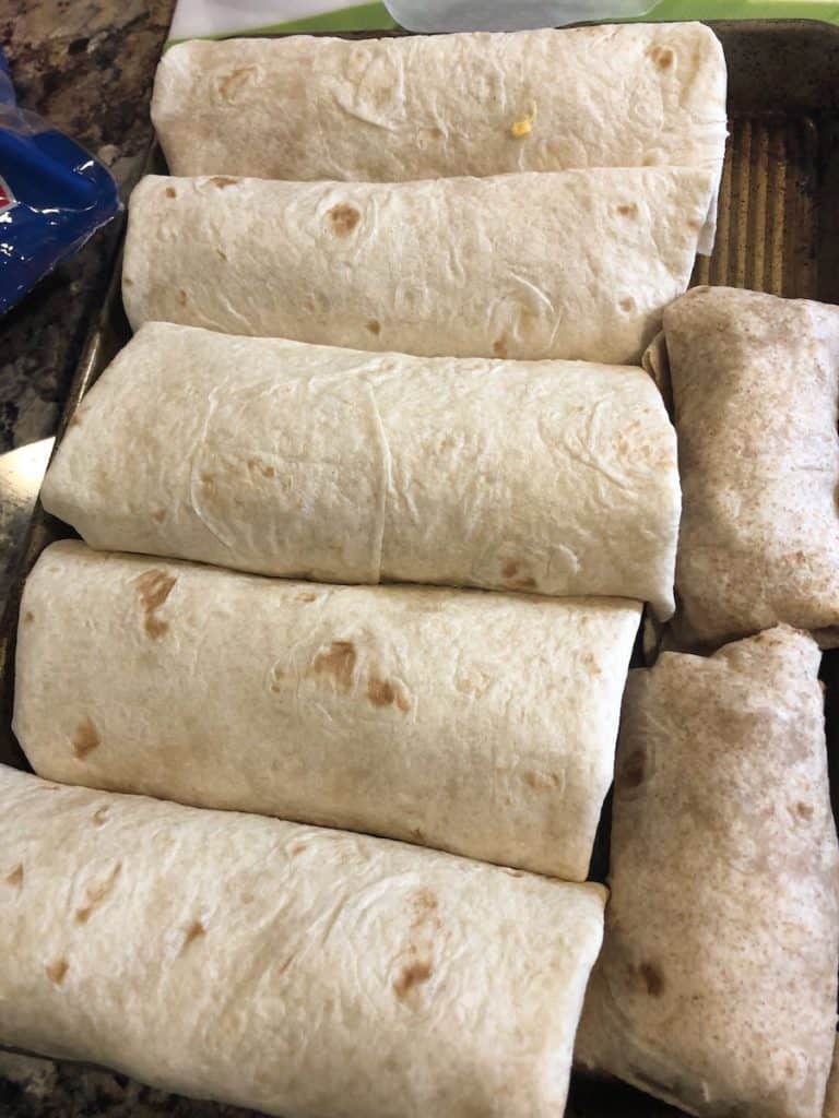 A stack of rolled breakfast burritos.