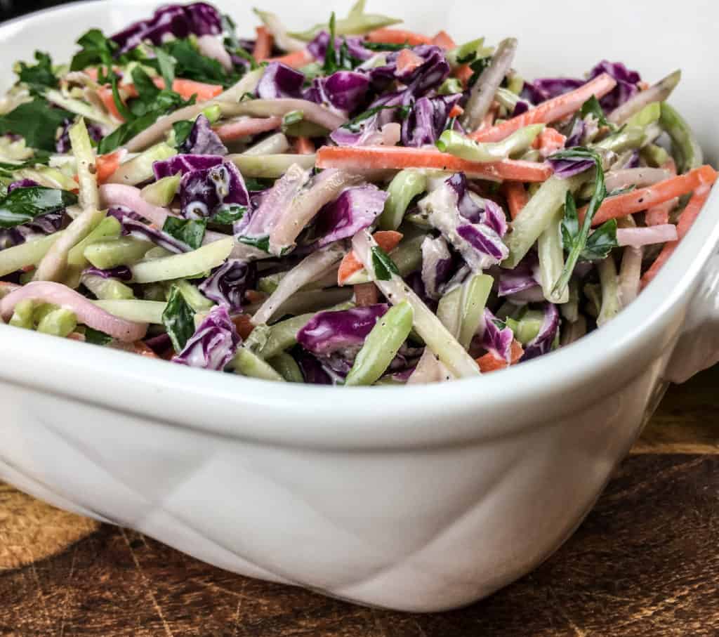 broccoli slaw with carrots and cabbage in a serving platter