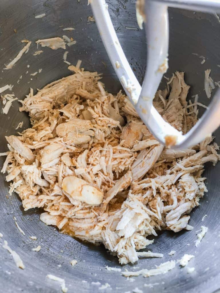 Shredded chicken in a mixing bowl.