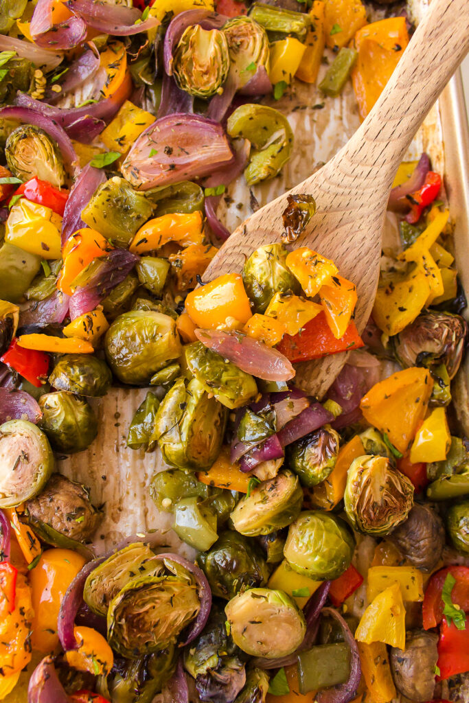 Mediterranean roasted vegetables on a wooden spoon.