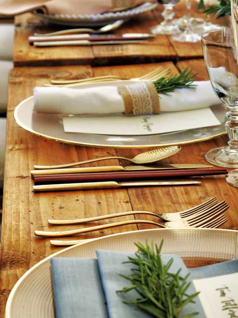 A place setting with gold silverwear.