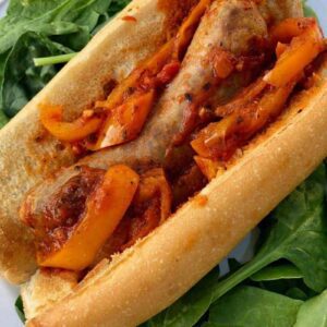 crockpot italian sausage and peppers on a bun with tomato sauce