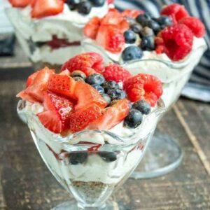 strawverries and blueberries with cheesecake in a parfait glass