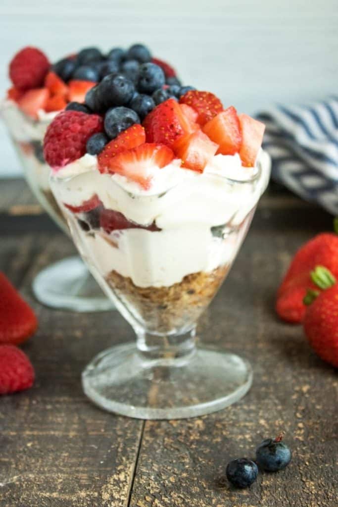 blueberries and strawberries with greek yogurt cheesecake in a glass
