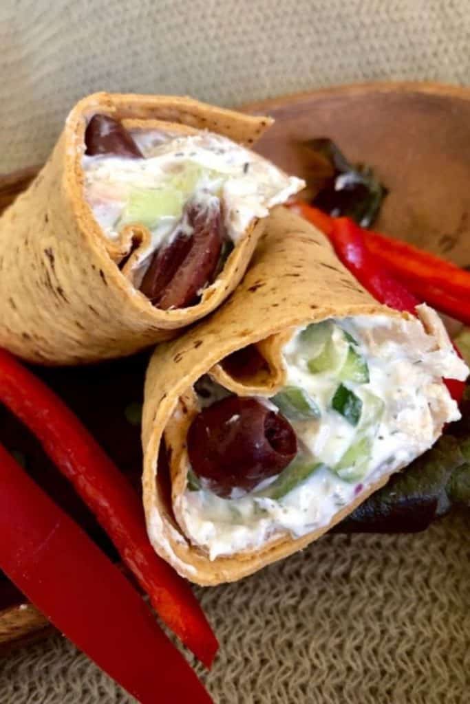 A chicken salad wrap with black olives.