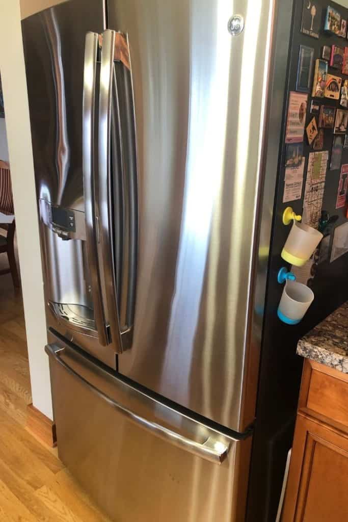 A shiny and clean french door refrigerator.