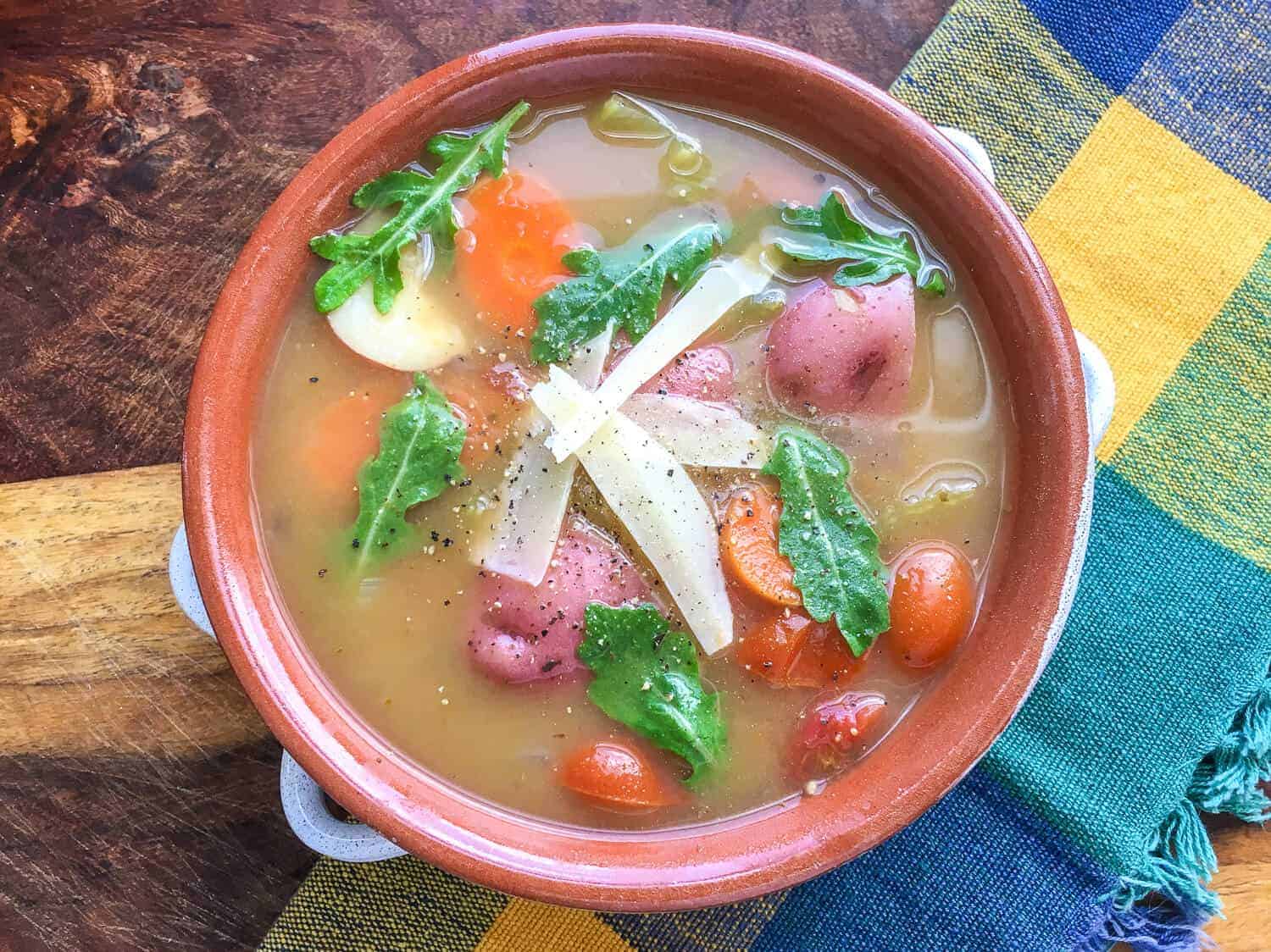 bowl of vegetable soup on a plaid napkin