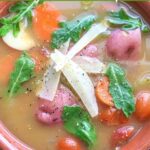 Soup with red potatoes and parmesan shavings.