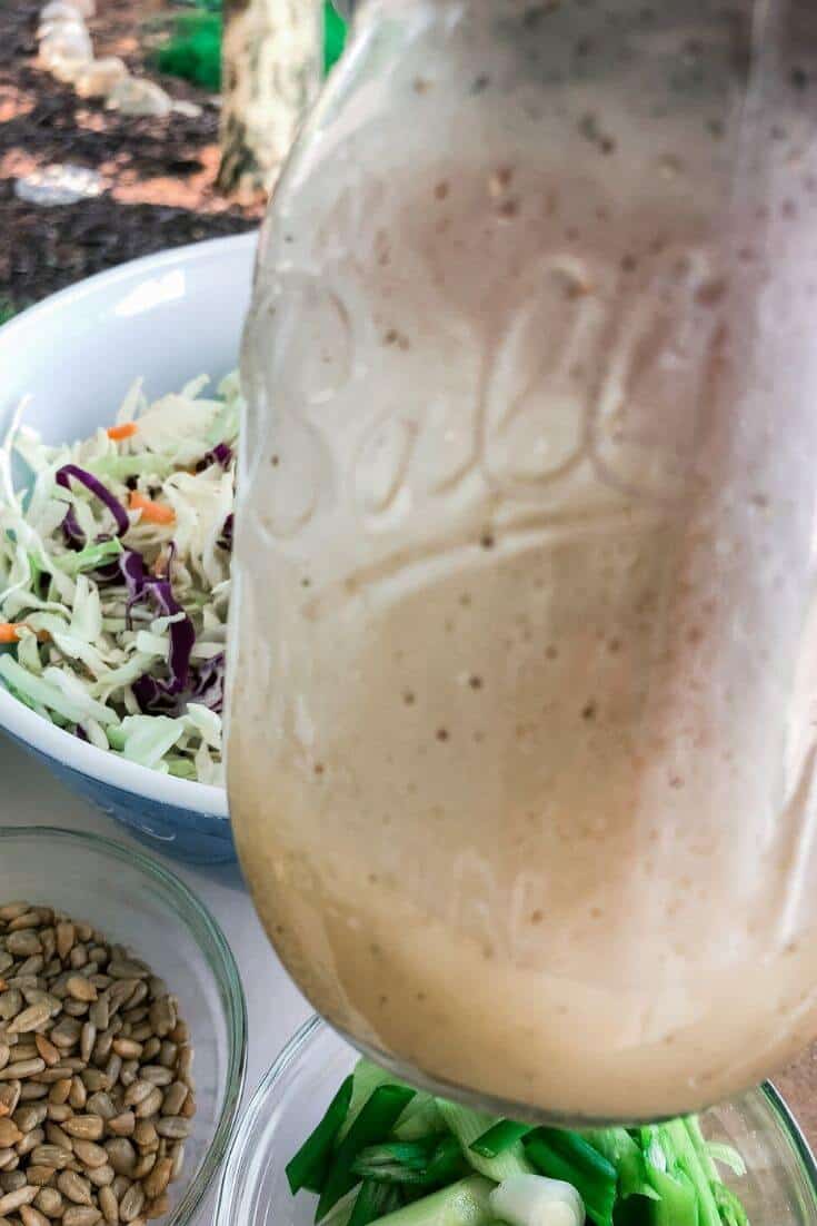 A dressing made in a mason jar for adding to an Asian cabbage salad.