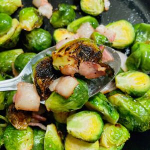 roasted Brussels sprouts with bacon on a serving spoon