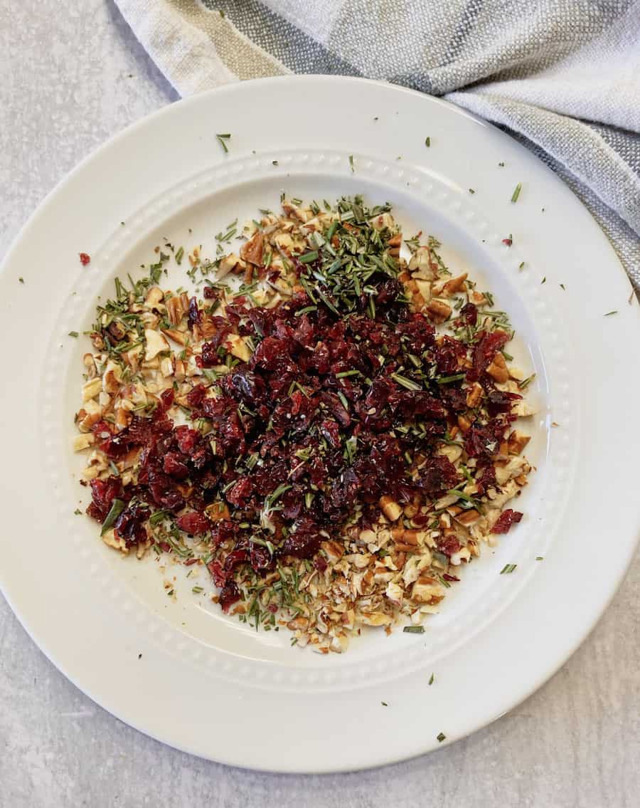 A coating goat cheese with cranberries, rosemary and pecans.