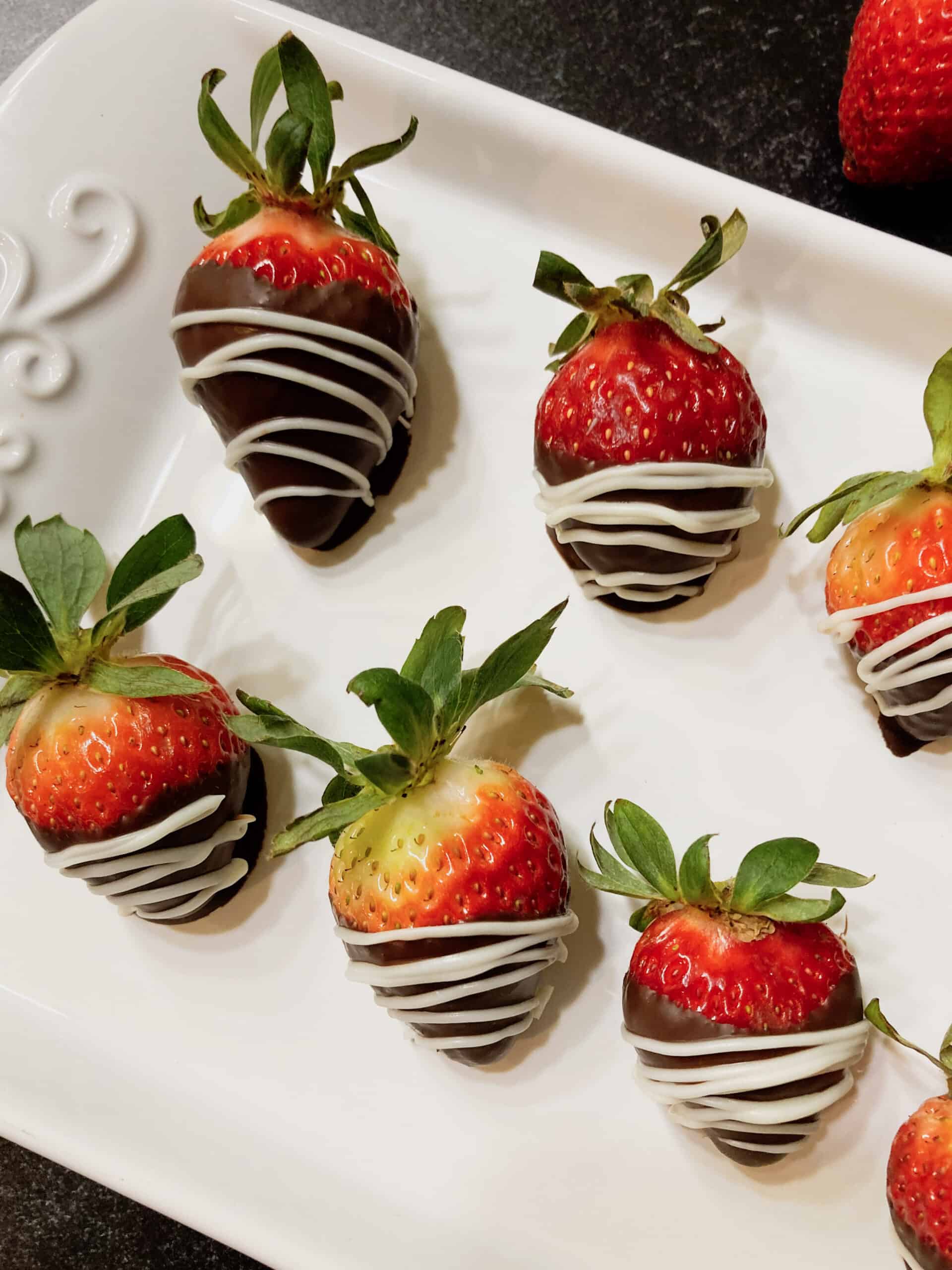 Chocolate covered strawberries on a platter.