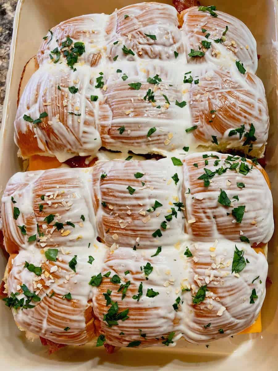 Chicken bacon ranch sliders brushed with butter, garlic and parsley.