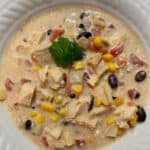 A bowl of creamy chicken chili with corn and black beans.