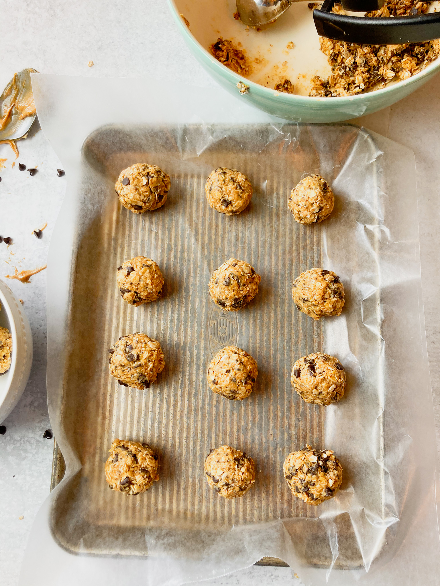 A tray of oatmeal bites with chocolate chips scooped out.