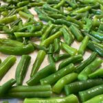 Chopped green beans on a sheet pan.
