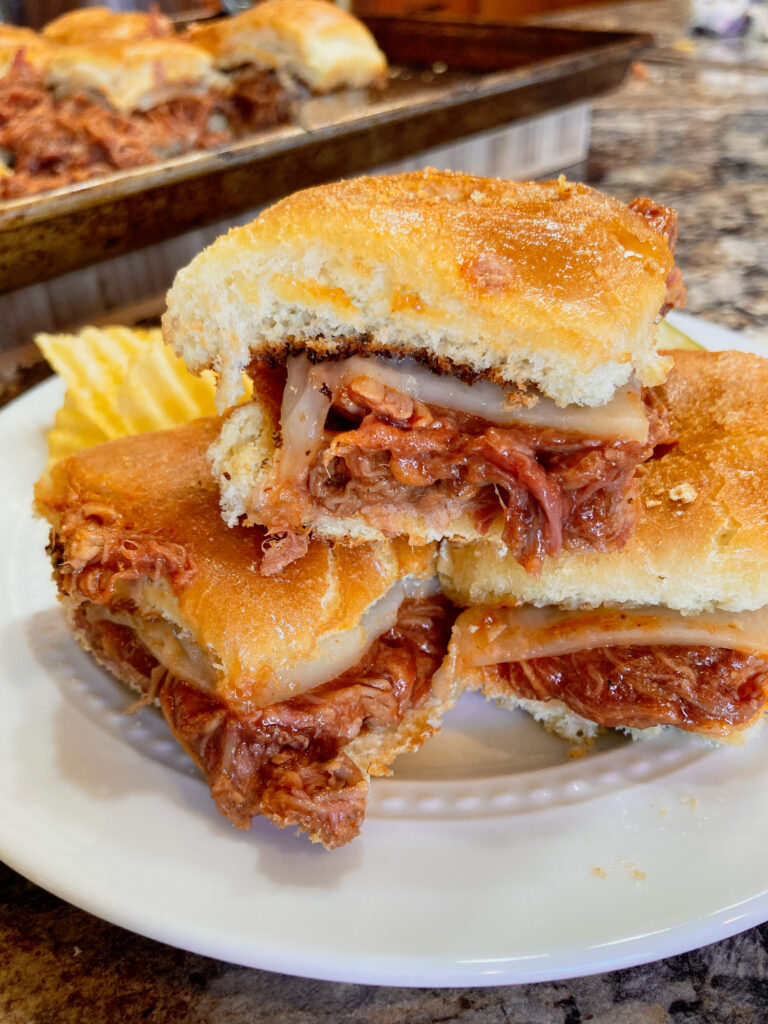 Pulled pork sliders on a plate.