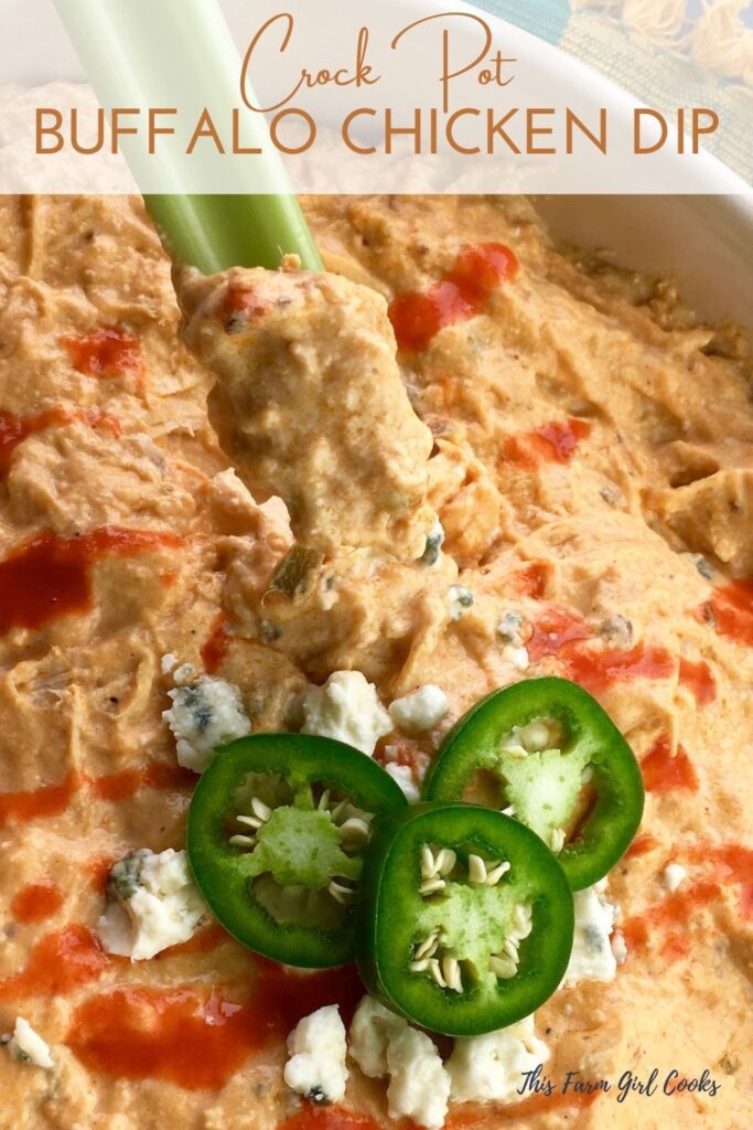 Buffalo chicken dip on a celery stick topped with sliced jalapeno peppers.