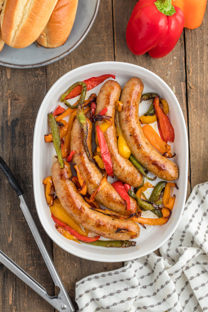 Cooked air fryer sausage and peppers on a platter.