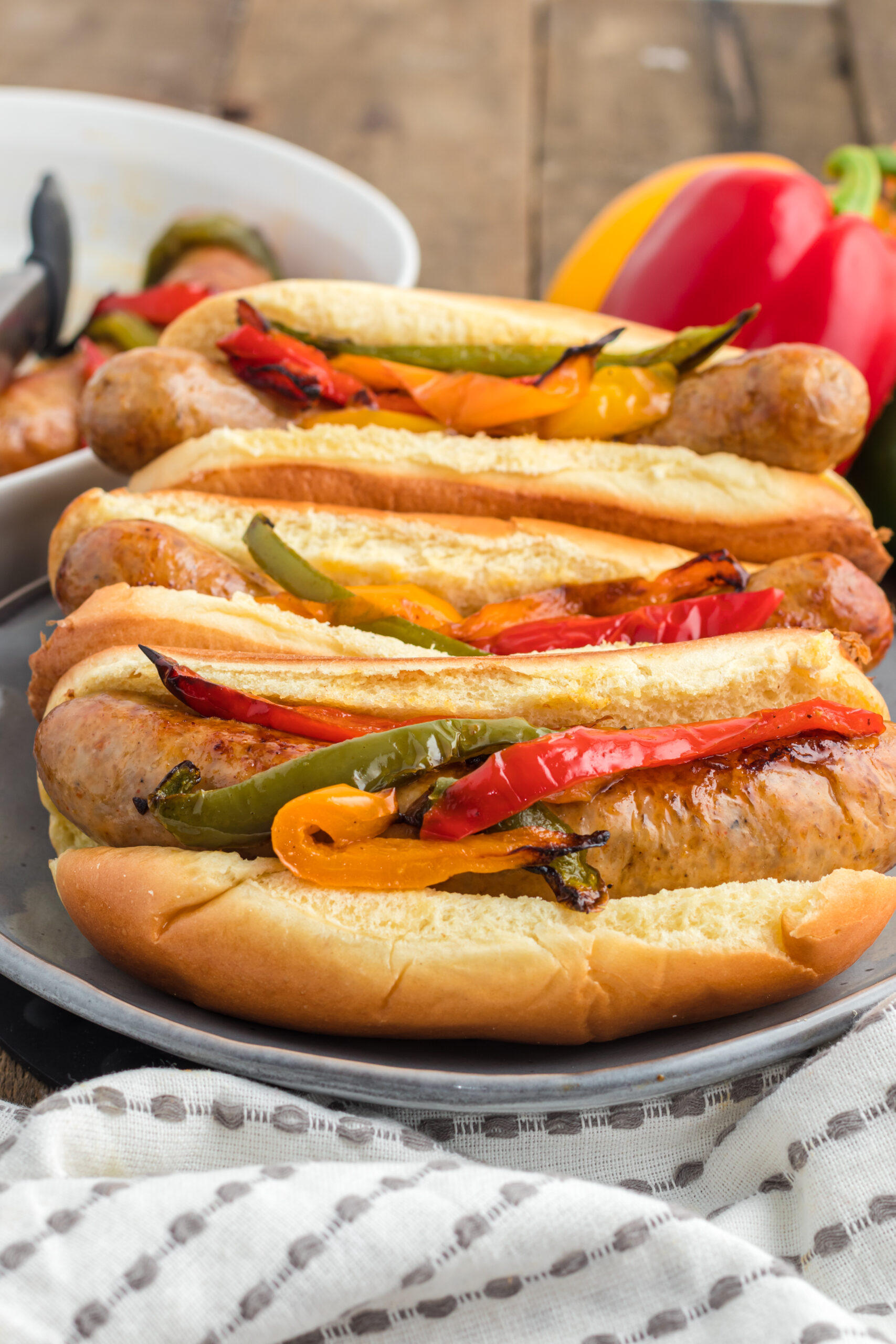 Air fried Italian sausages with peppers on toasty buns.