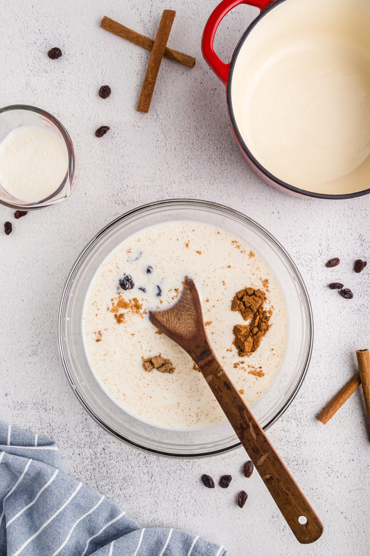 Mixing milk, eggs, and uncooked rice for baked rice pudding.