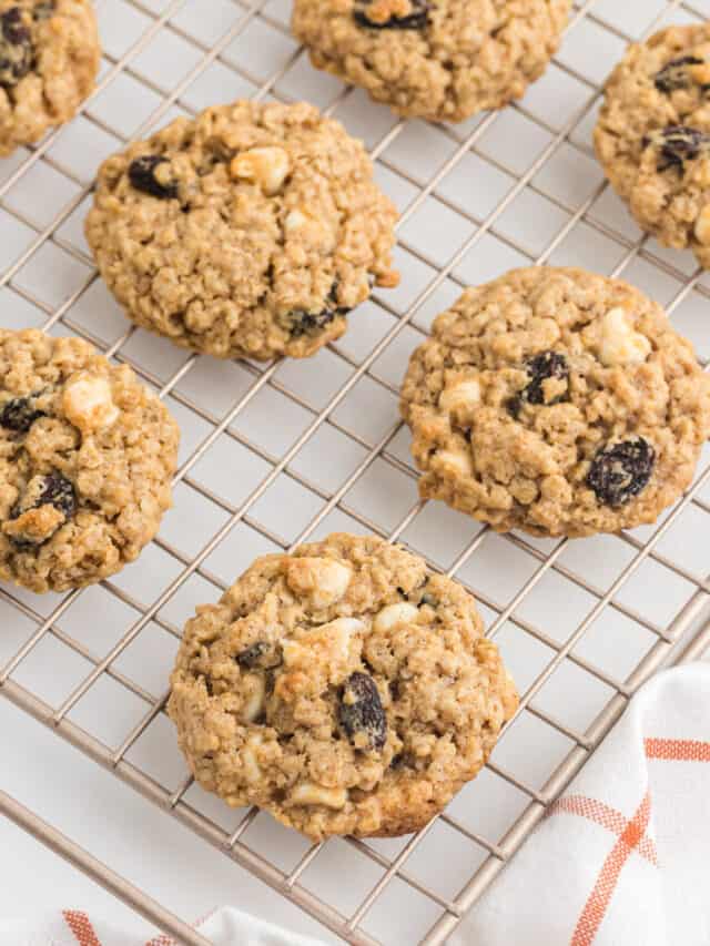 Overhead view of freshly baked oatmeal spice cookies on cooling rack.