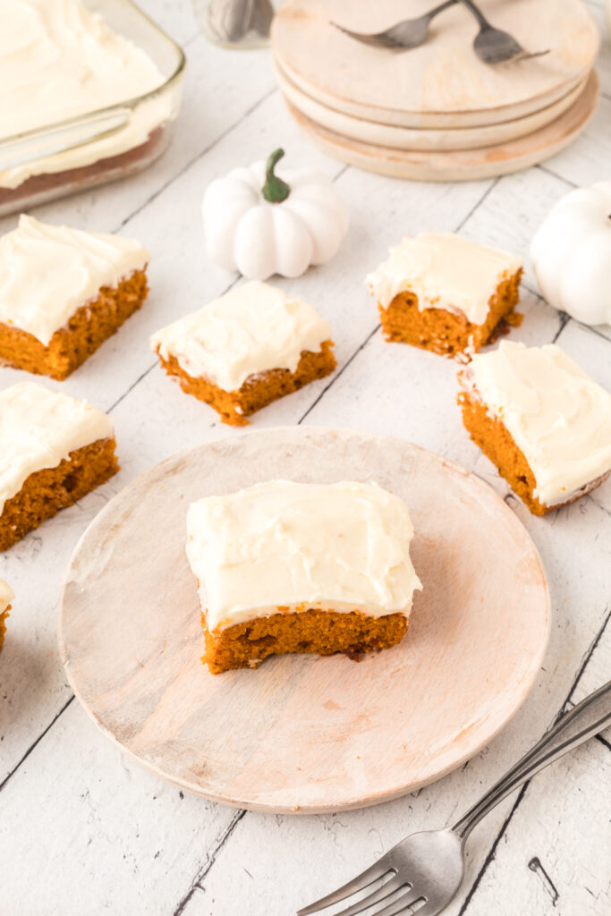 Pumpkin snack cake pieces on a table and plate.