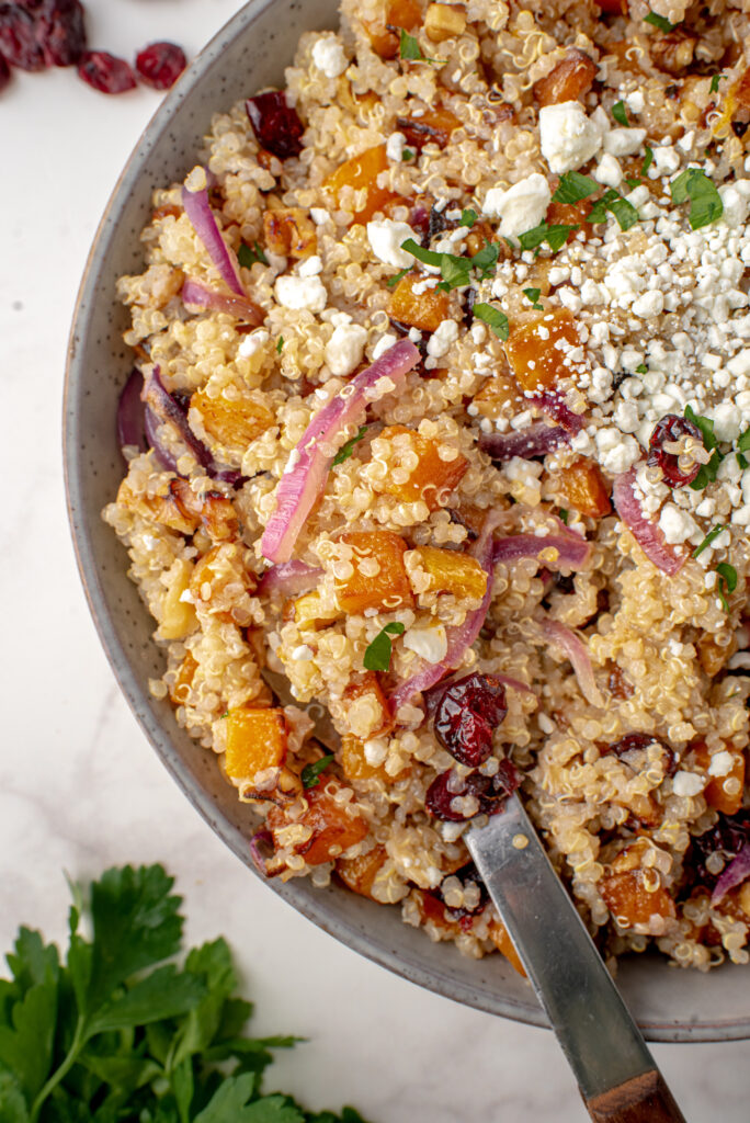 Quinoa salad with butternut squash, dried cranberries, and red onions.