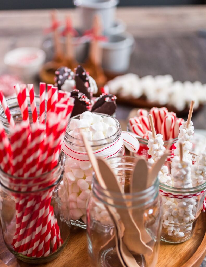 Decorative straws and marshmallows in jars.