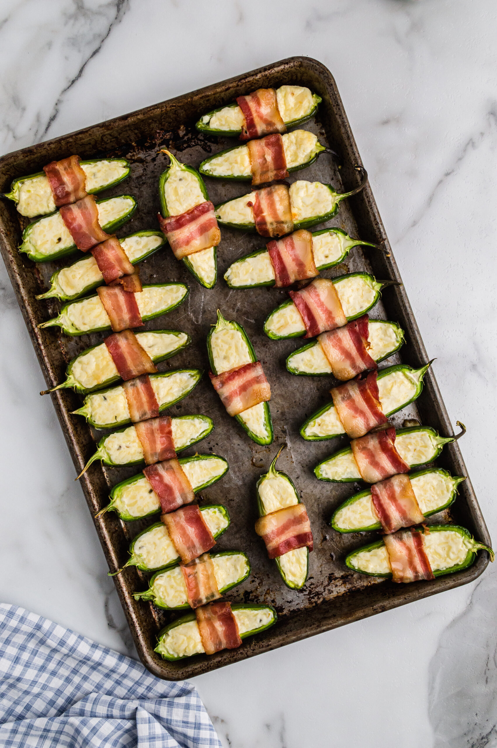 jalapeno poppers on a baking sheet