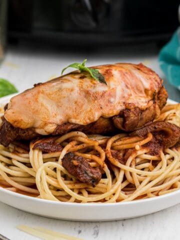Crockpot Chicken Parmesan served over spaghetti.