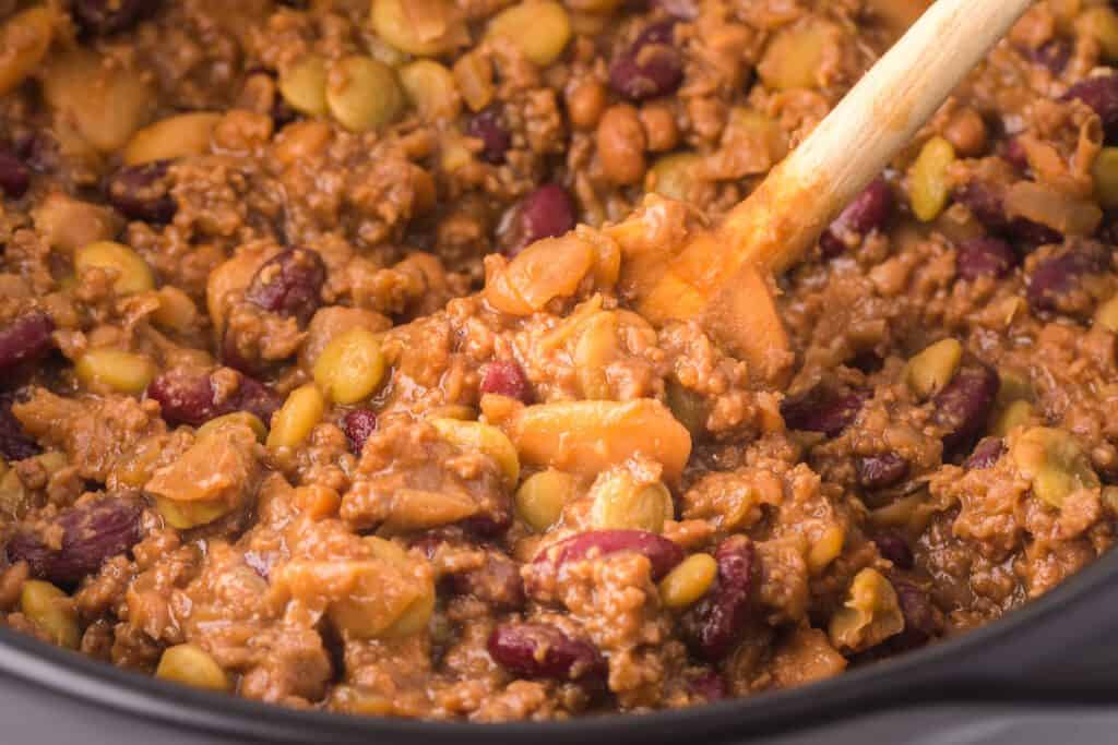 Cowboy baked beans with hamburger in a large pot.