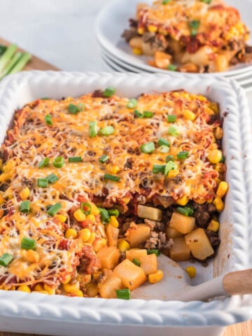 Ground beef casserole with potatoes in a baking dish.