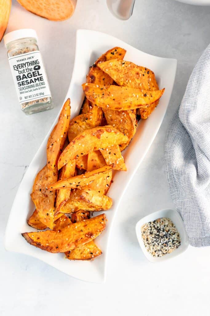 Sweet potato wedges with everything seasoning on a platter.