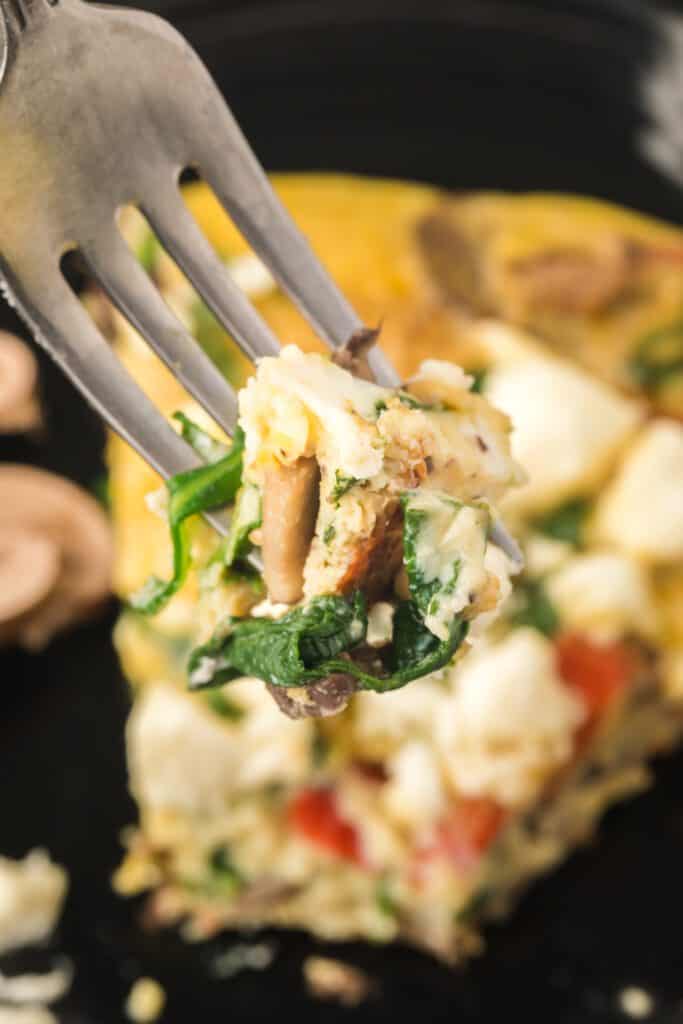 close up of a bite of frittata with spinach