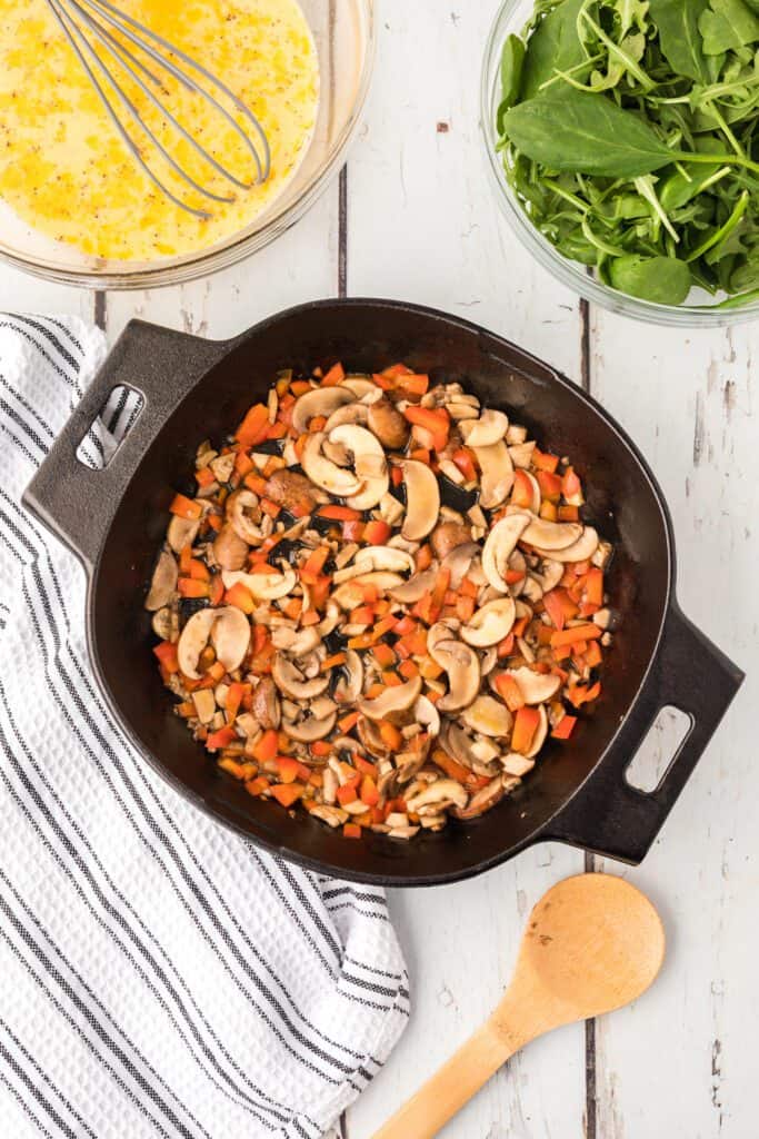 chopped mushrooms and peppers in a skillet