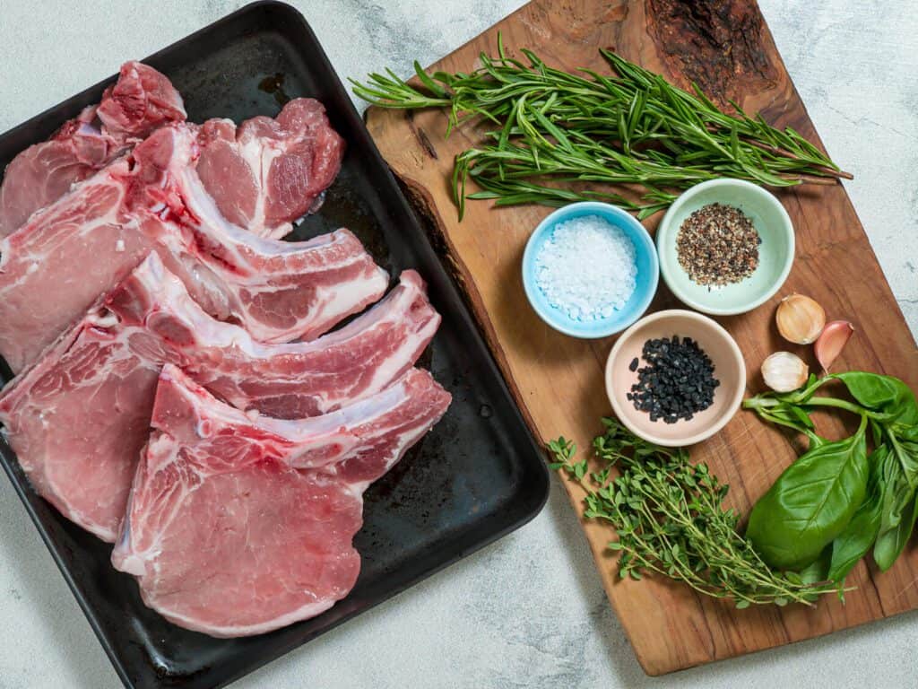 ingredients for grilled pork chops on a platter