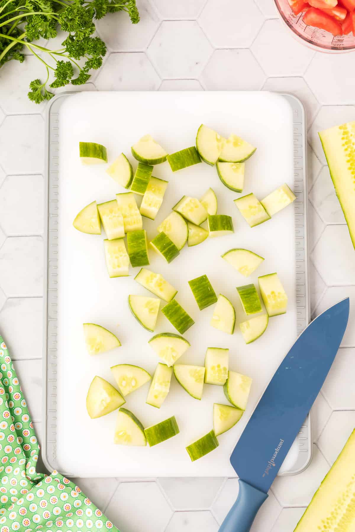 Sliced cucumbers on a cutting board with a knife.