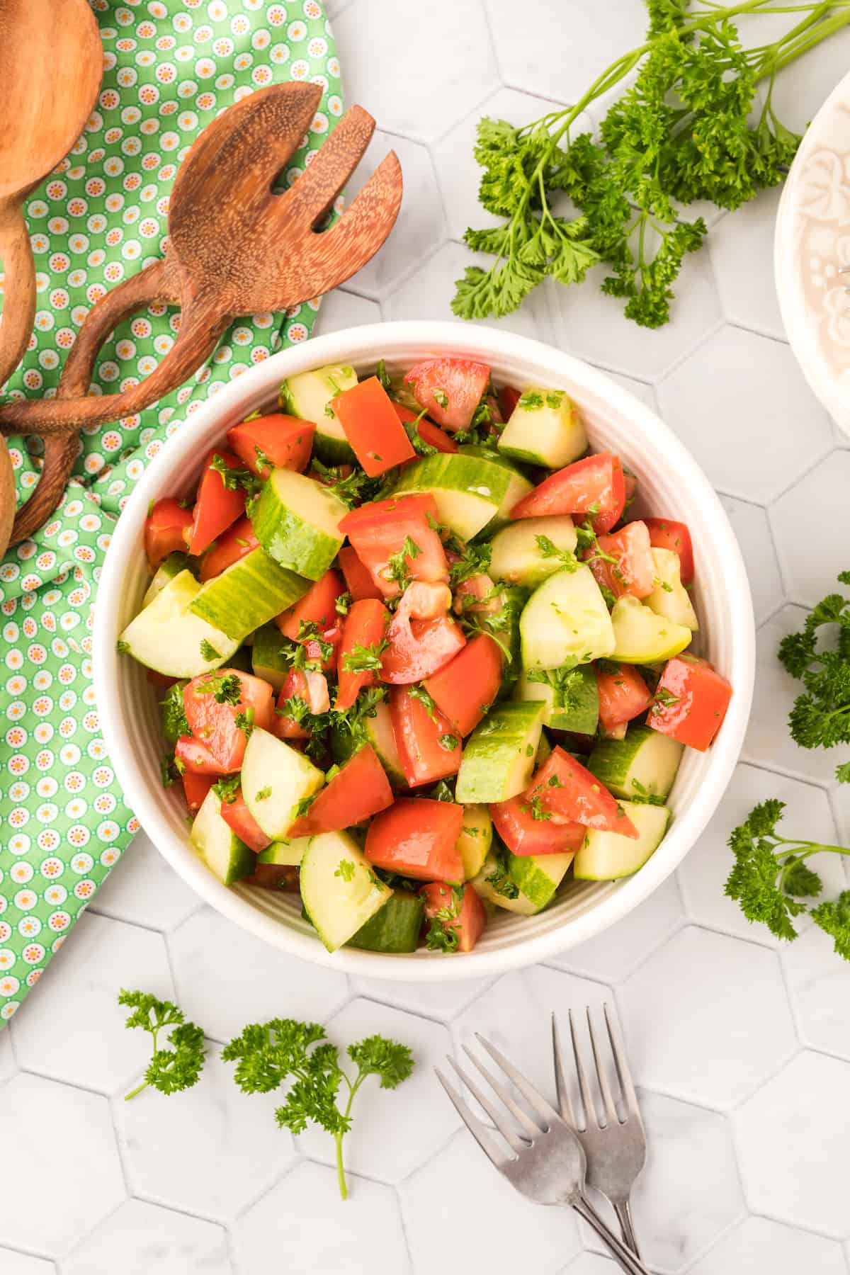tomatoes, cucumber and parsley in a salad bowl