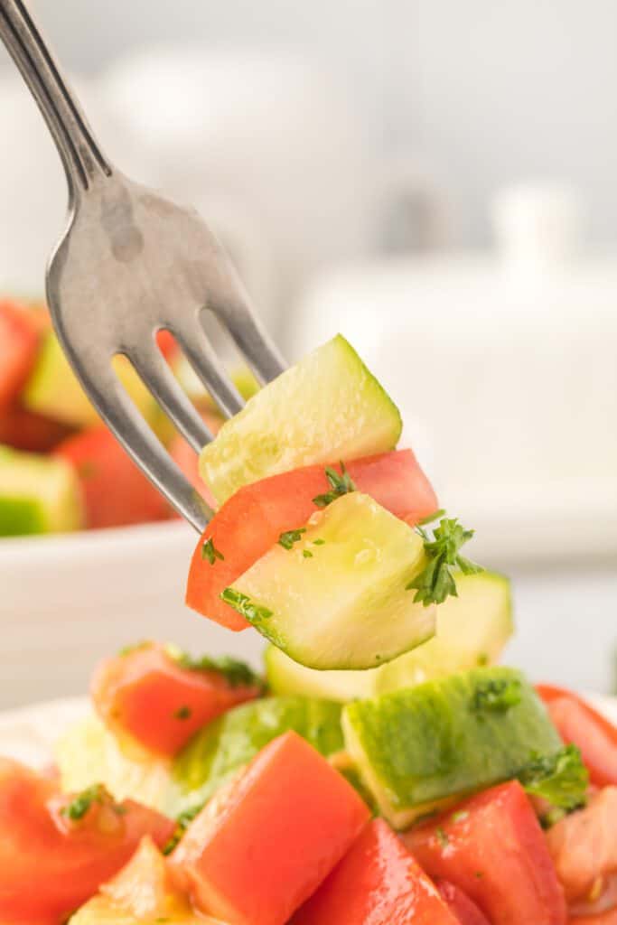 tomatoes and cucumber on a fork