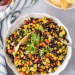 Black bean and corn dip in a bowl with tortilla chips.