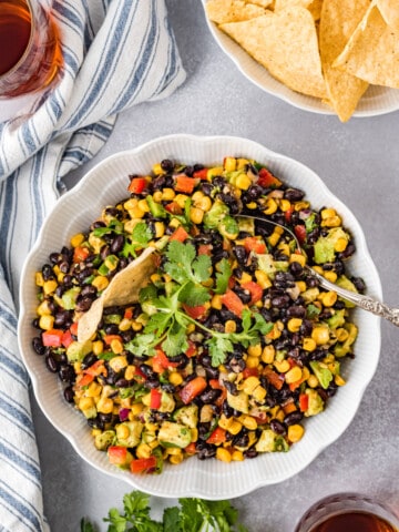 Black bean and corn dip in a bowl with tortilla chips.