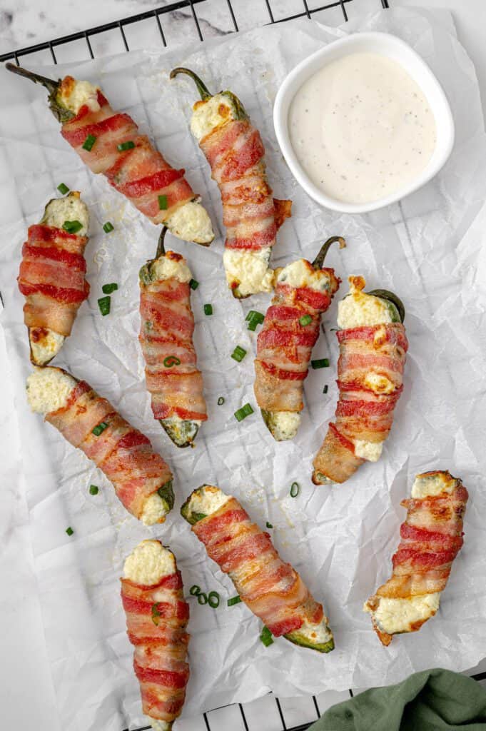 Cream cheese stuffed jalapeno pepper halves wrapped in bacon.