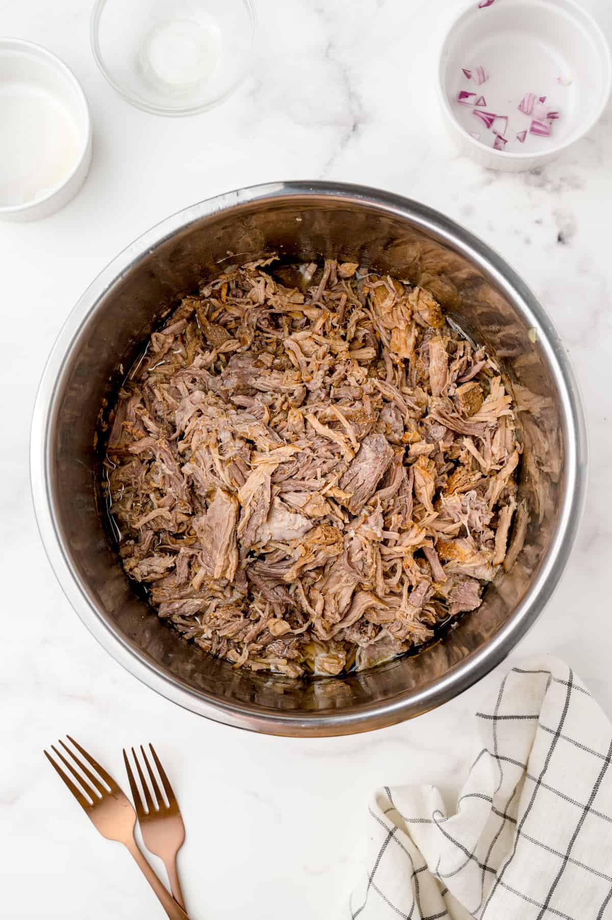 Shredded pulled pork tossed in barbecue sauce inside the Instant Pot for extra flavor.