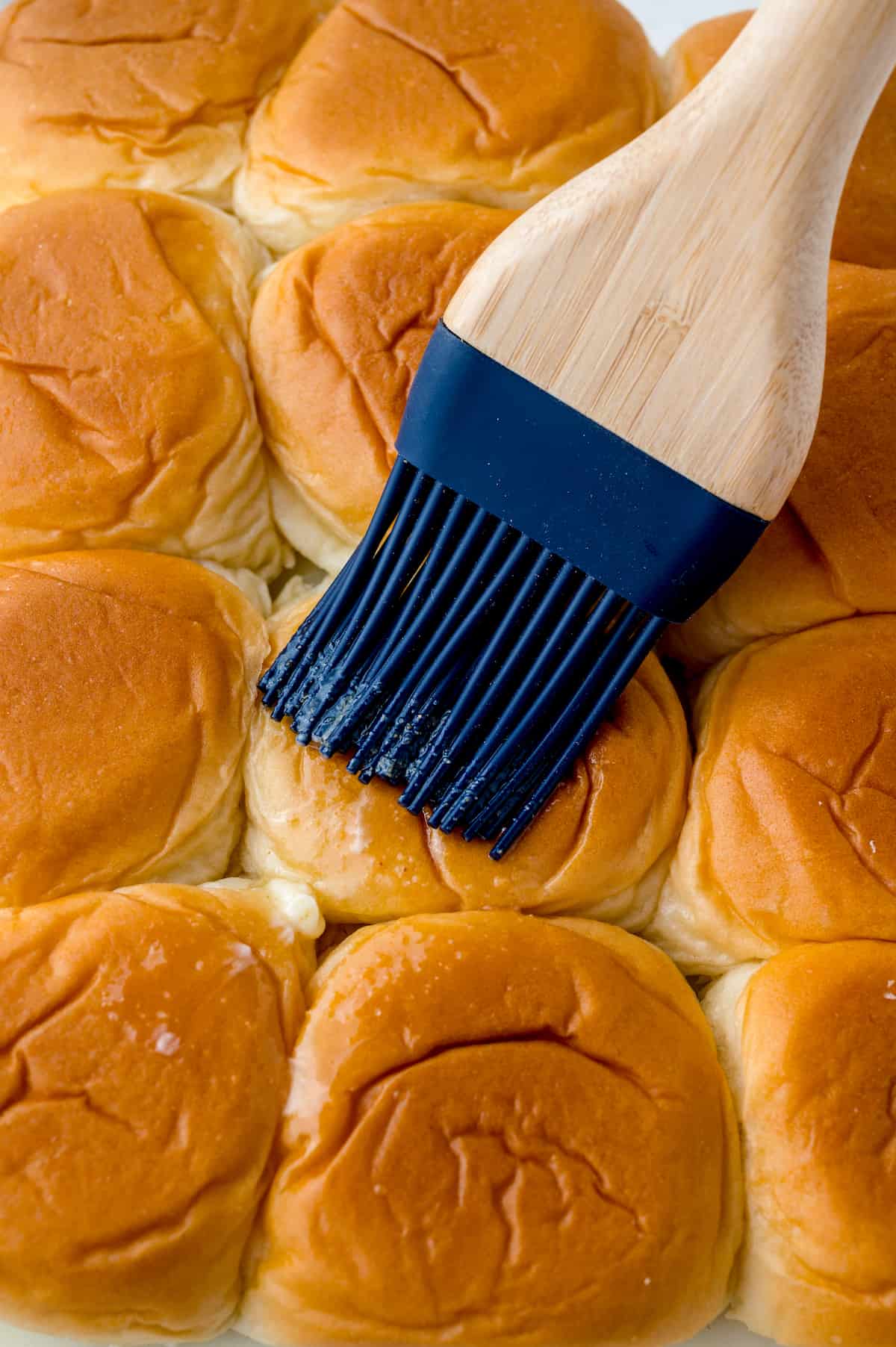 Slider buns brushed with melted butter and garlic.